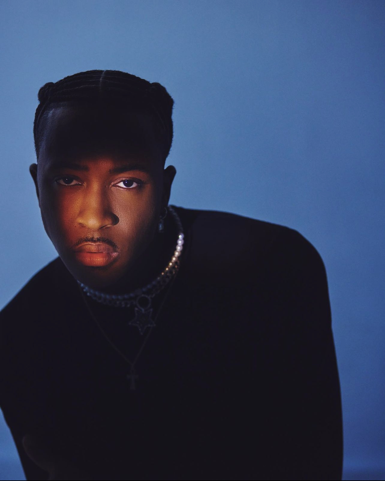 Close portrait of KIMANII against a blue background